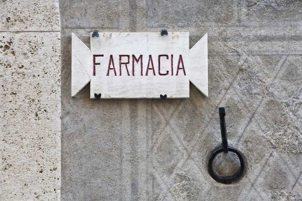 Italy, Tuscany, Pienza Pharmacy sign on wall